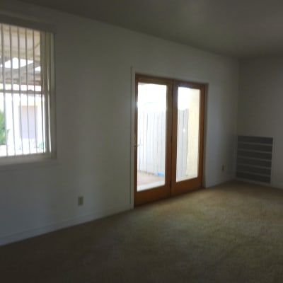 A living room with french doors in a home at Capeharts in Ridgecrest, California