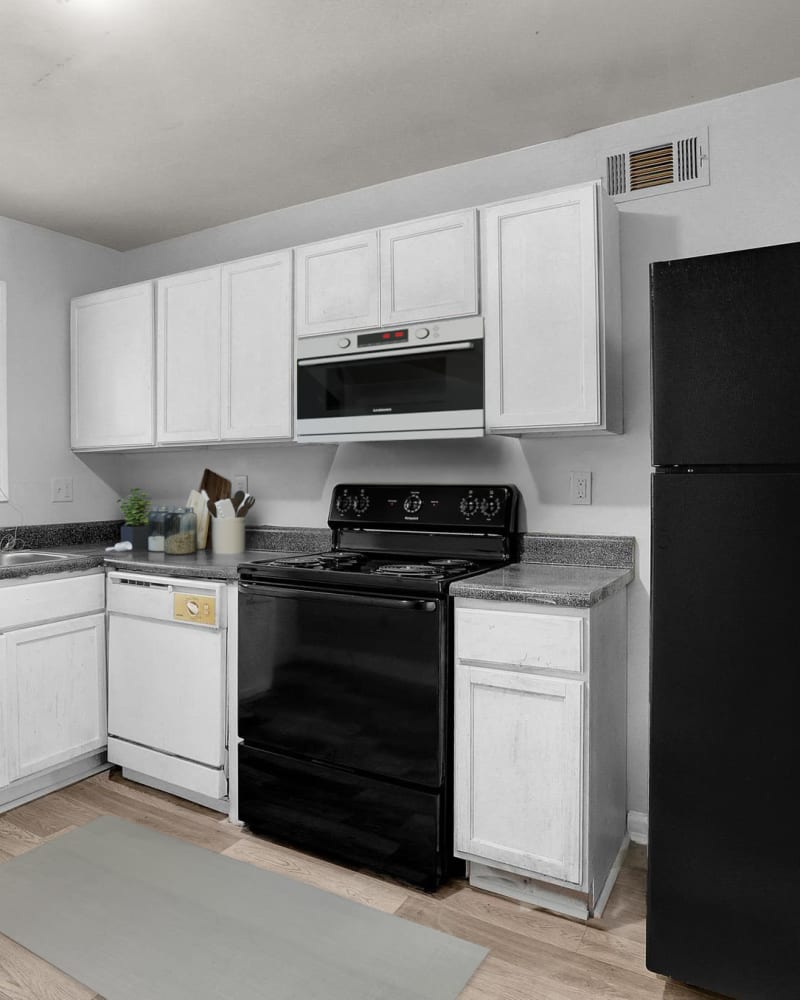 White cabinets and black appliances in a model kitchen at Stanton View Apartments in Atlanta, Georgia