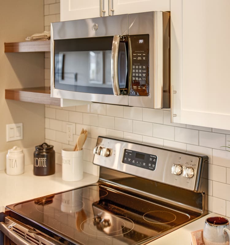 Subway tile backsplash and stainless-steel appliances in a model home's kitchen at Harbor Point Apartments in Mill Valley, California