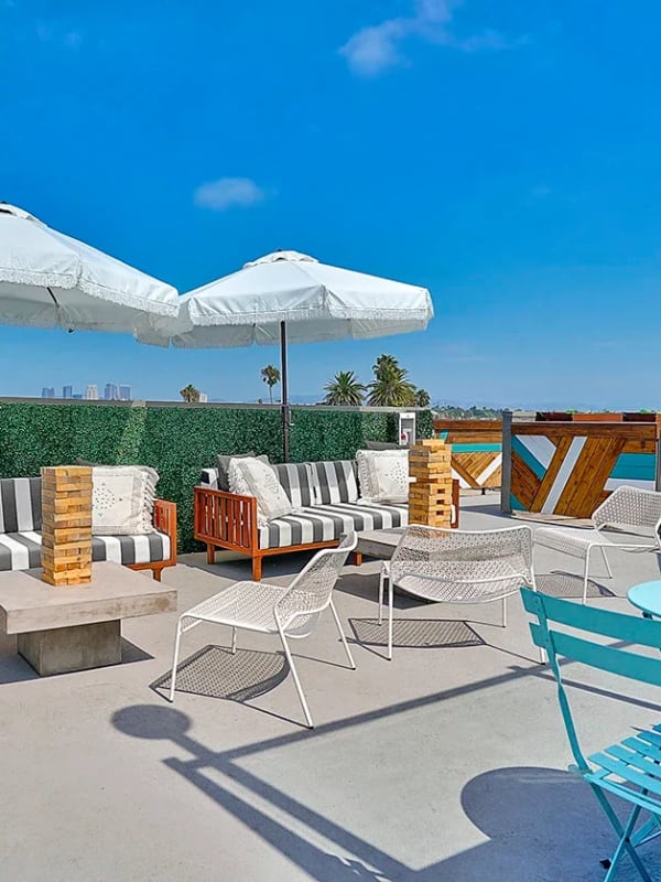 Outdoor seating area with games at Indie Westside in Los Angeles, California