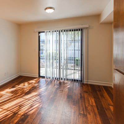 A home with wood flooring and a sliding glass door at Howard Gilmore Terrace in La Mesa, California