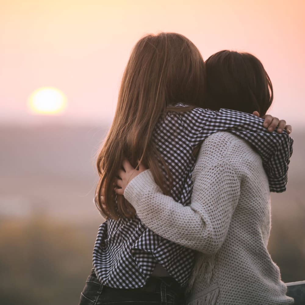 A couple hugging and celebrating their Refer a Friend bonus at STOR-N-LOCK Self Storage