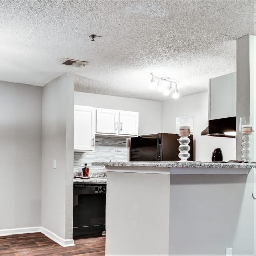 Modern kitchen with white cabinets at Gregory Lane Apartments in Acworth, Georgia