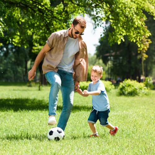 A resident and his son playing soccer at a park near Hilleary Park in San Diego, California