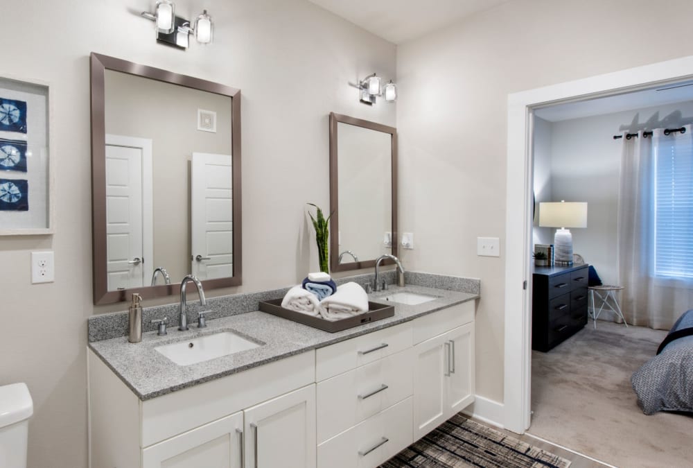 Two granite countertop sinks in bathroom of model home at The Elysian in St Johns, Florida