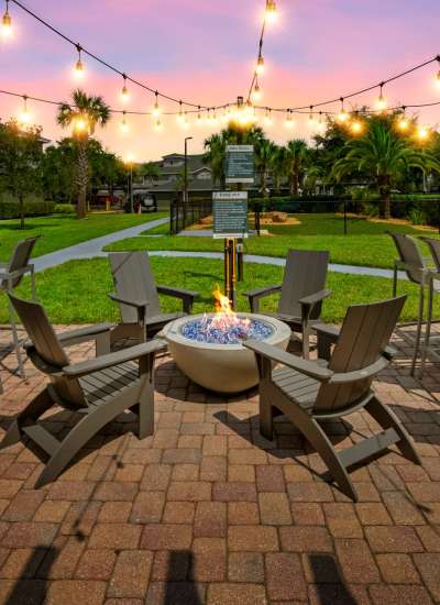 Summer kitchen with firepit at Pointe Parc at Avalon in Orlando, Florida