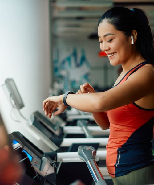 Resident working out in fitness center at Westside Terrace, Los Angeles, California 