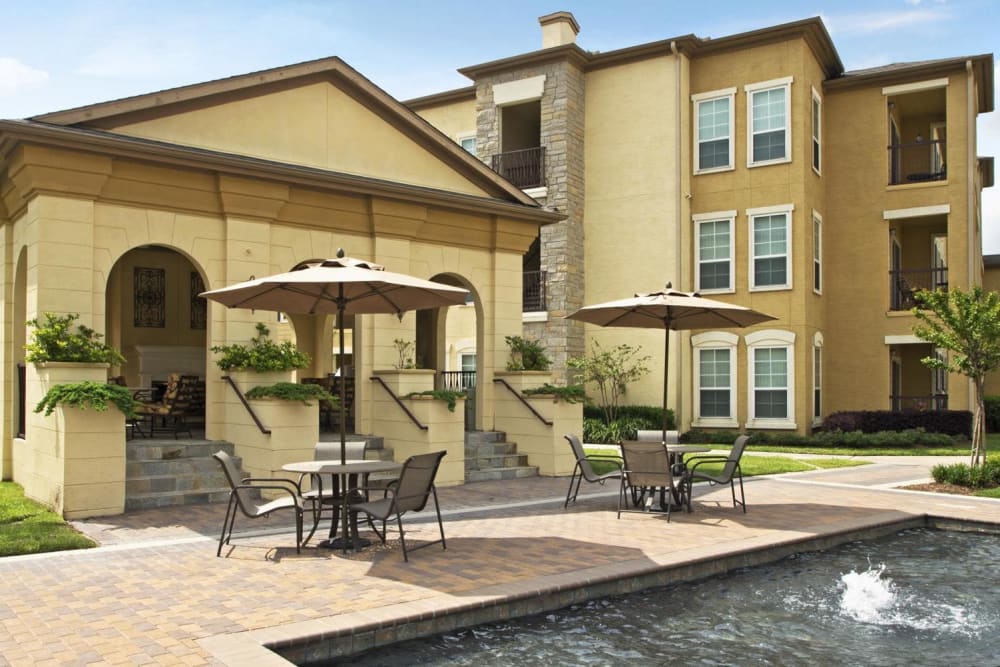 Community Pool Area with Seating and Umbrellas at Amalfi at Tuscan Lakes in League City, Texas