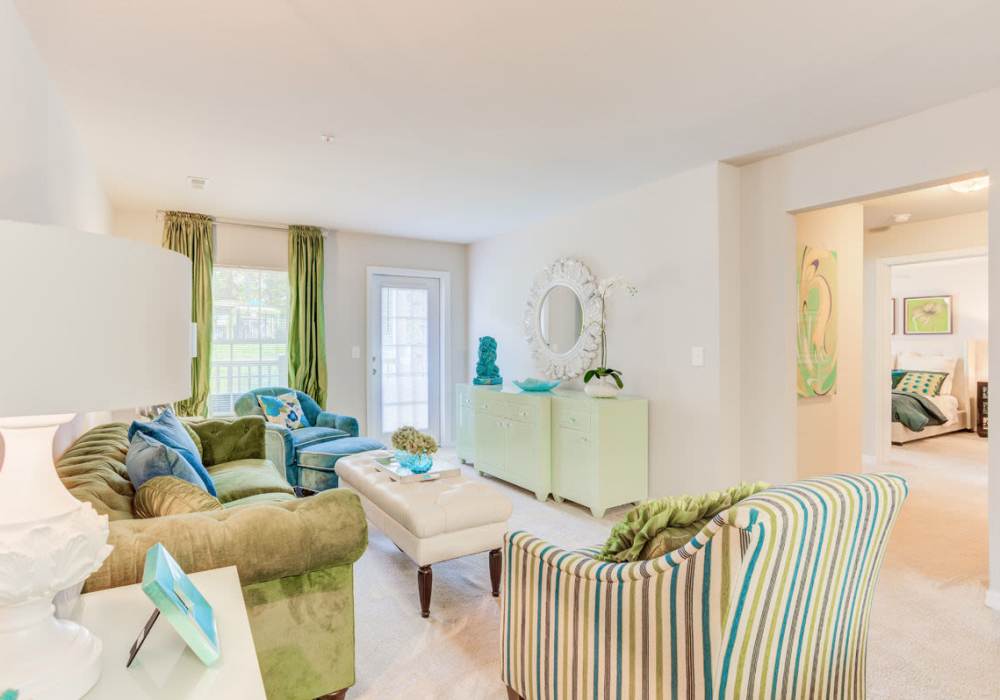 Brightly lit and open living room with access to front door with a glass window Innisbrook Village in Greensboro, North Carolina