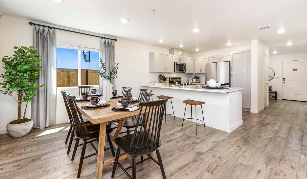 Kitchen and dining area with wood-style plank flooring at Isles in Roseville, California