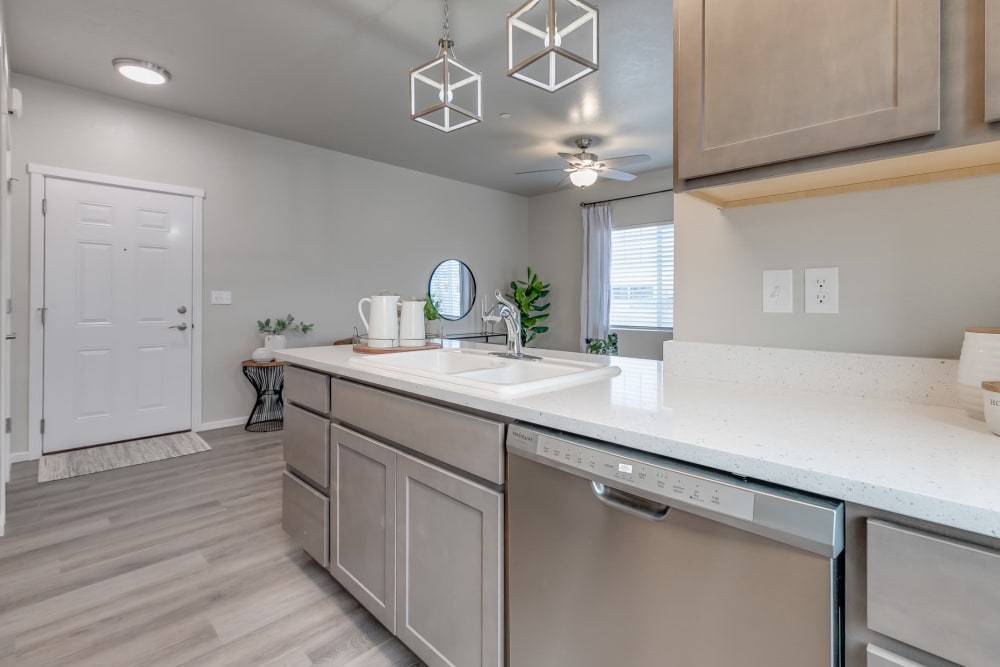 Stainless steel appliances and quartz  countertops in a gourmet kitchen at Olympus at Ten Mile in Meridian, Idaho