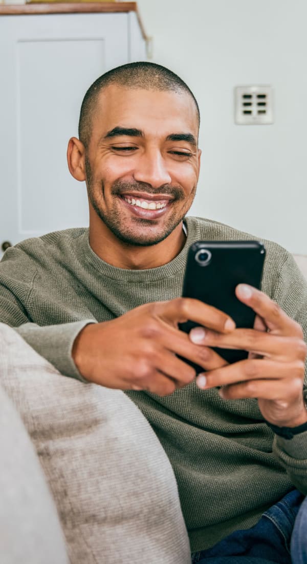 Caretaker on his phone at Living Care Lifestyles in Seattle, Washington