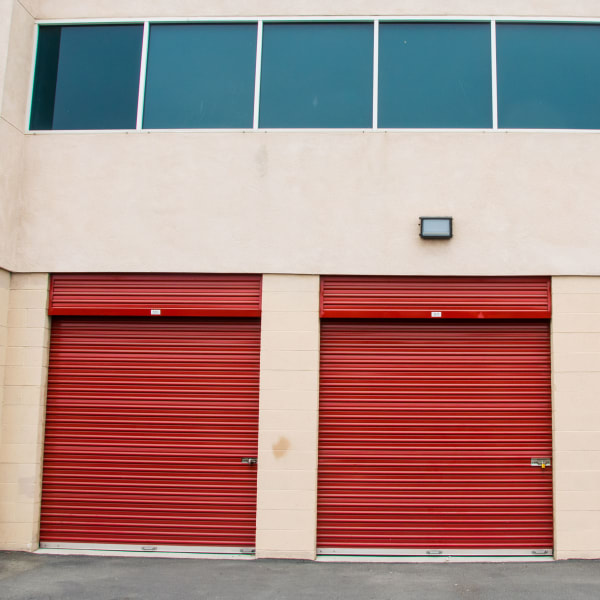 Outdoor storage units with red doors at StorQuest Self Storage in Long Beach, California