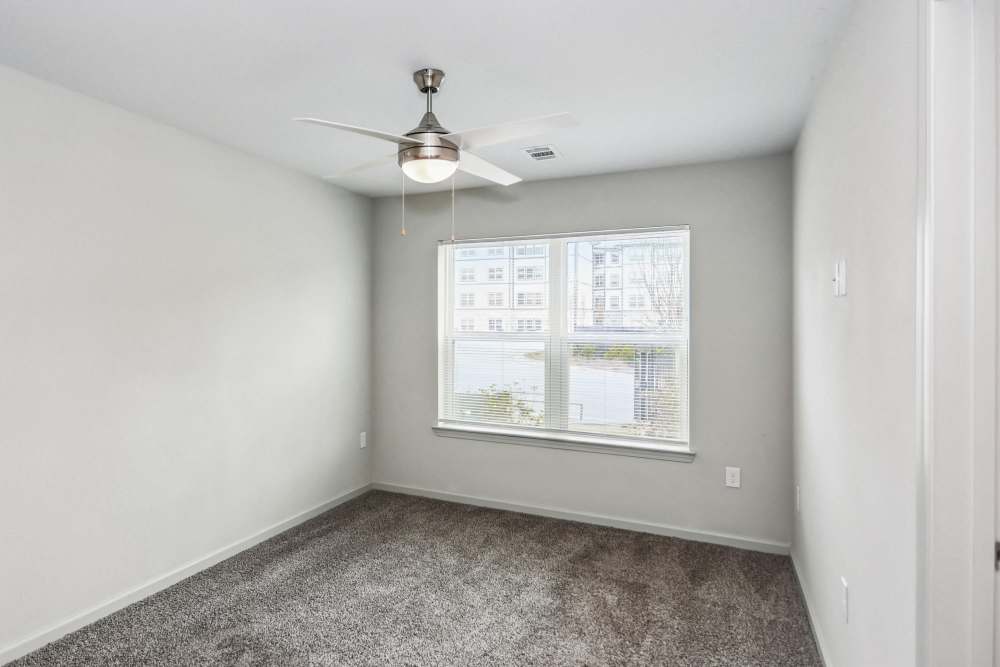 Unfurnished bedroom with a ceiling fan at Flats at Mount Zion in Stockbridge, Georgia