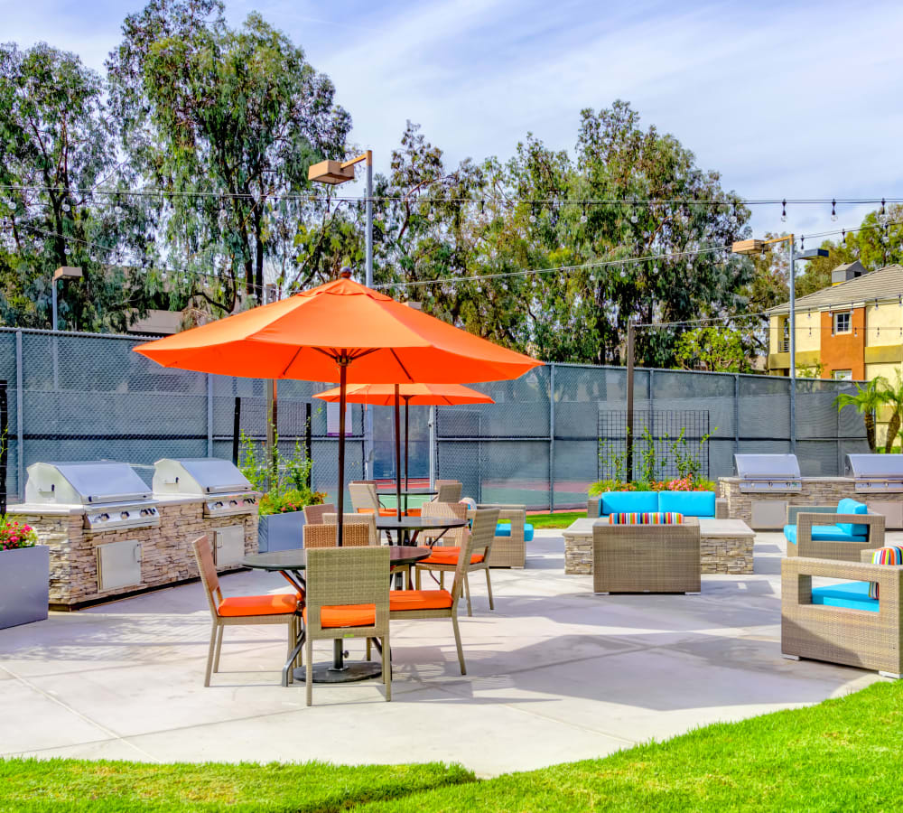 Barbecue area with a fire pit and lounge seating at Sofi Irvine in Irvine, California