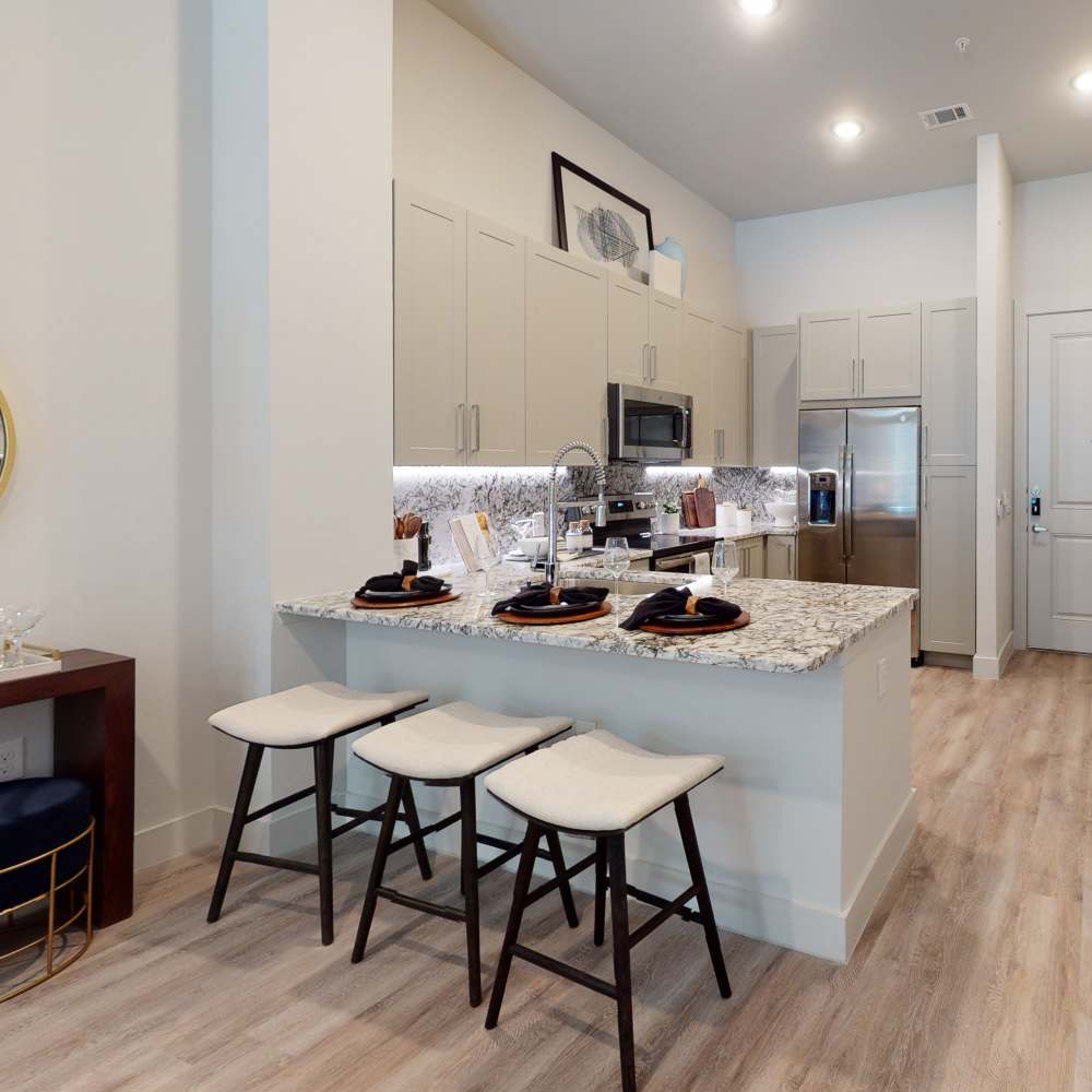Kitchen with breakfast bar at Cornell Midtown in Dallas, Texas