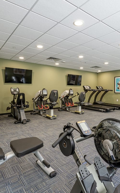 Fitness center with cardio and weight machines at The Pillars of Hermantown in Hermantown, Minnesota