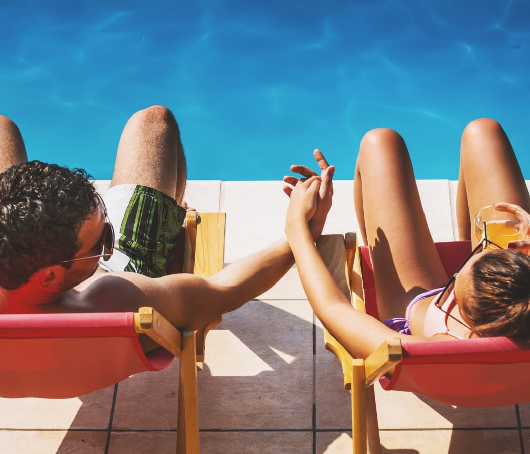 Couple relaxing near pool at The Paramount