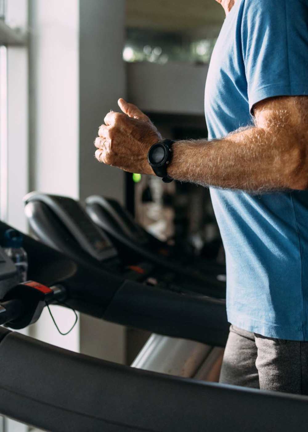 Resident workingout on a treadmill in the fitness center at The Hardison in Salt Lake City, Utah   