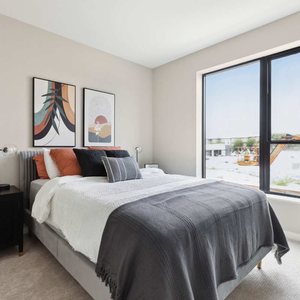 Bedroom with cozy bed at Oaks Pentagon Village in Edina, Minnesota
