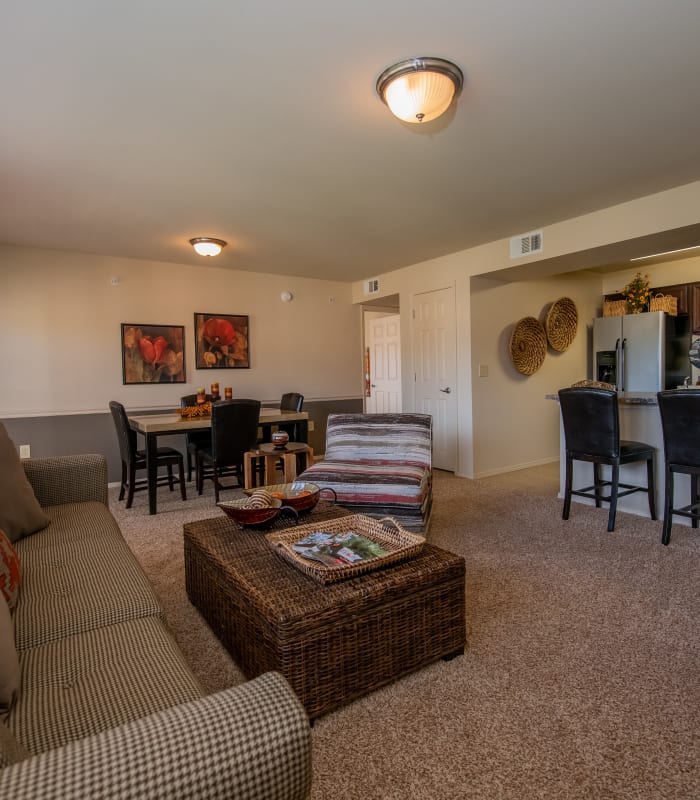 Carpeted living room and kitchen bar at Park at Tuscany in Oklahoma City, Oklahoma