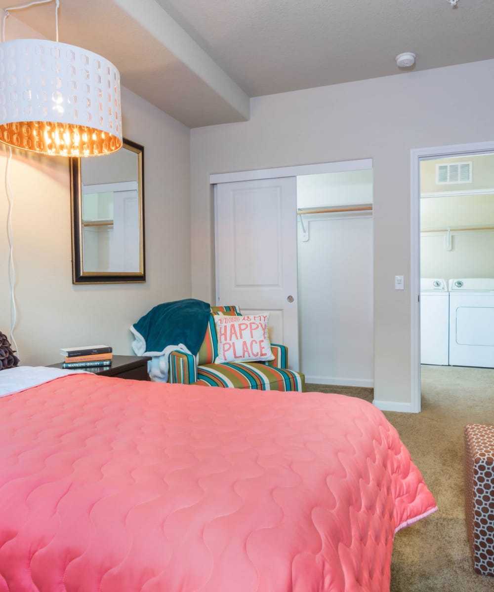 Colorful bedroom with door to laundry at The Jones in Hillsboro, Oregon