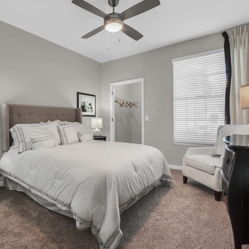 A furnished bedroom with a ceiling fan at Grandewood Pointe in Orlando, Florida