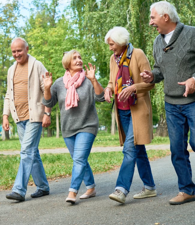 Residents out for a walk on a paved nature trail near Estoria Cooperative Lakeville in Lakeville, Minnesota