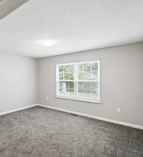 Carpet floored bedroom at North River Landing in Elkhart, Indiana