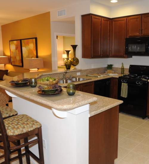 Modern kitchen with counter tops at Cresta Bella in San Diego, California