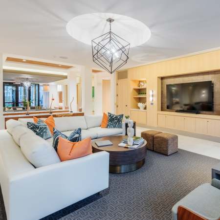 Club room with an elegant neutral color palette at The Reverie at Lake Boone in Raleigh, North Carolina