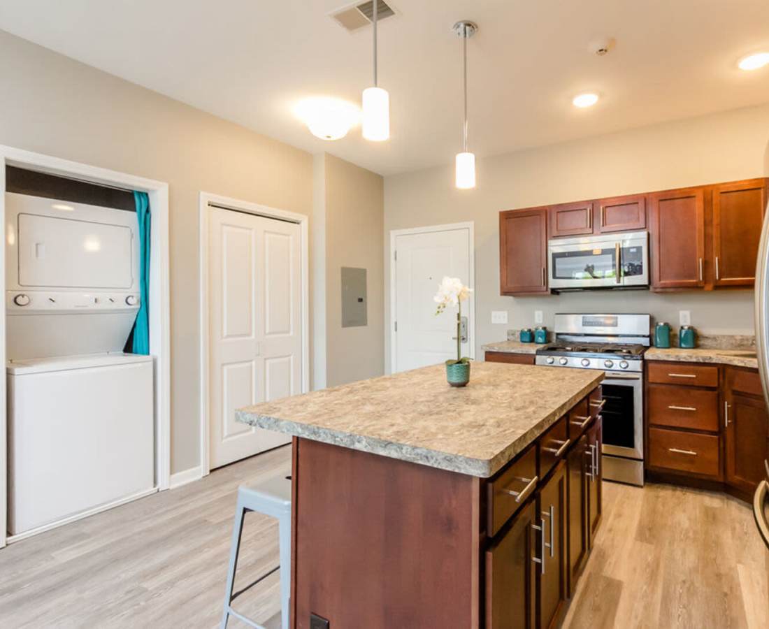 Kitchen with built-in appliances and adjacent storage area at Eagle Ridge Circle in Rochester, New York
