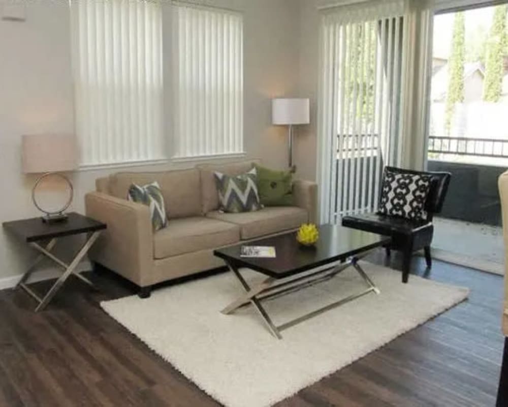 Living room with sliding door to balcony at  Seville at Mace Ranch in Davis, California