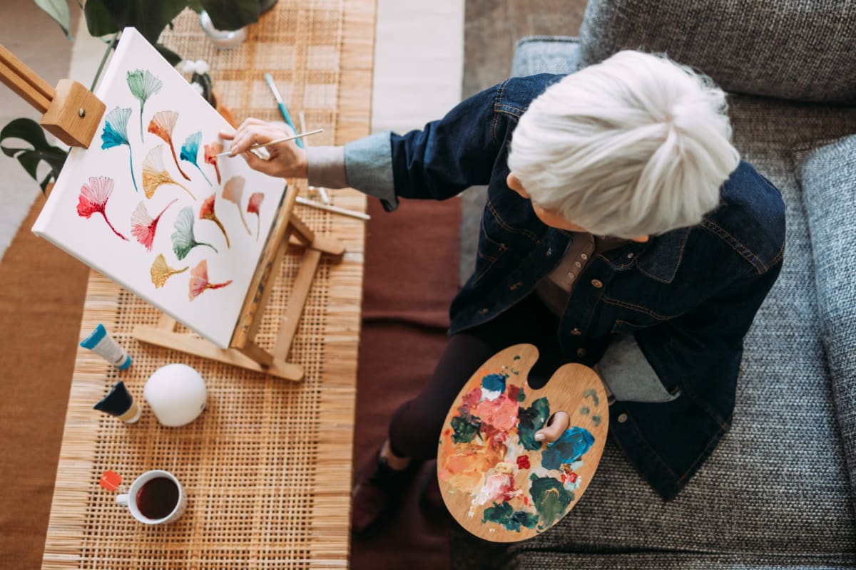 Senior woman painting watercolors at Oxford Vista Wichita in Wichita, Kansas