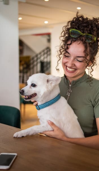 A resident holds her dog at University Lofts at Greensborough Village, Jonesboro, Arkansas