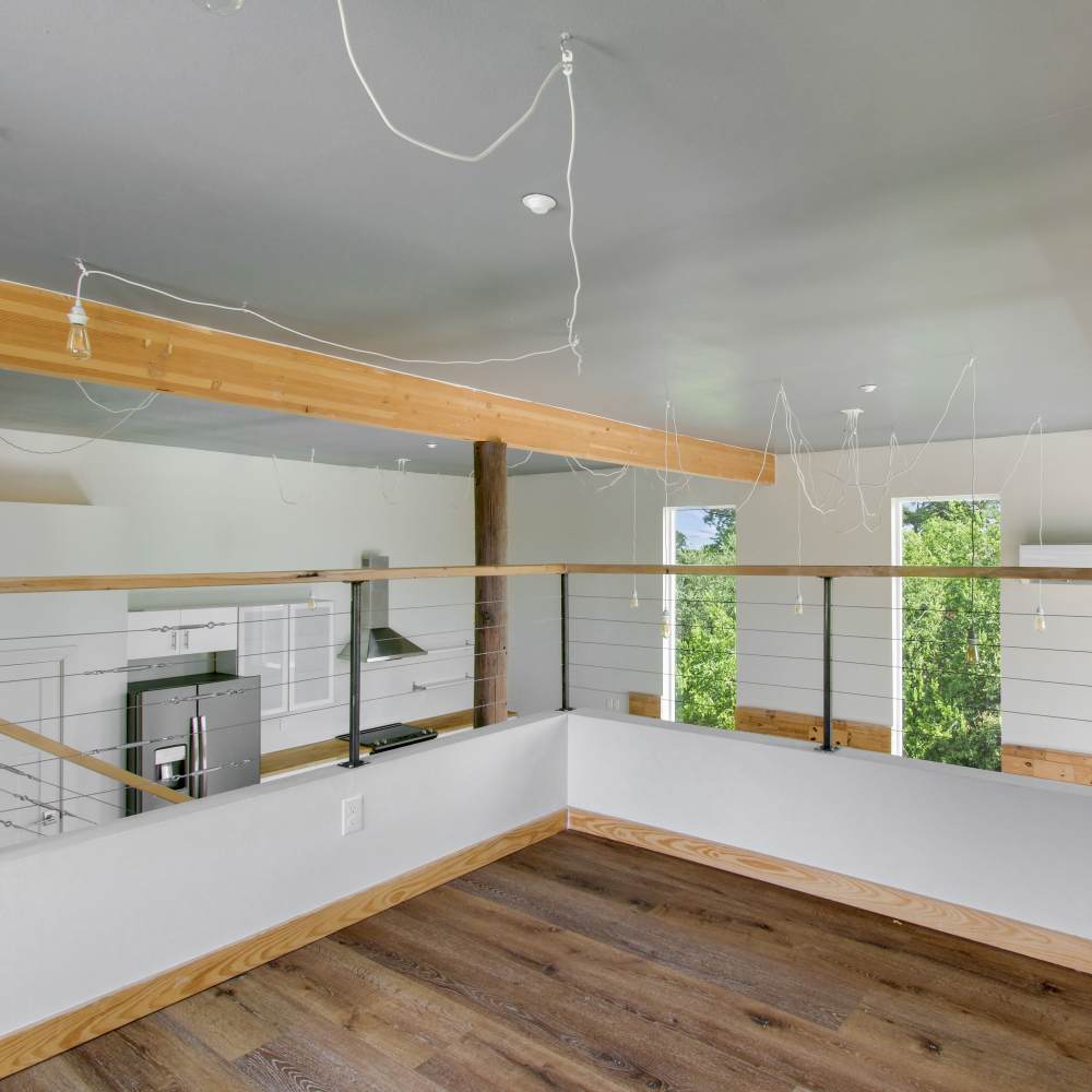 Loft area with view of kitchen at The Lofts at 305 in Bryan, Texas