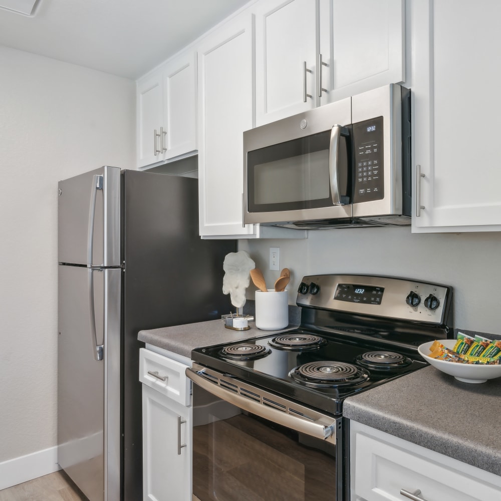 Open-concept kitchen with stainless steel appliances at Haven Poway in Poway, California