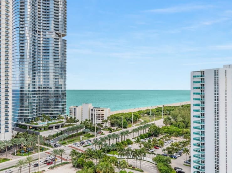 View of the beach and surrounding buildings from a balcony at Marina Del Viento in Sunny Isles Beach, Florida