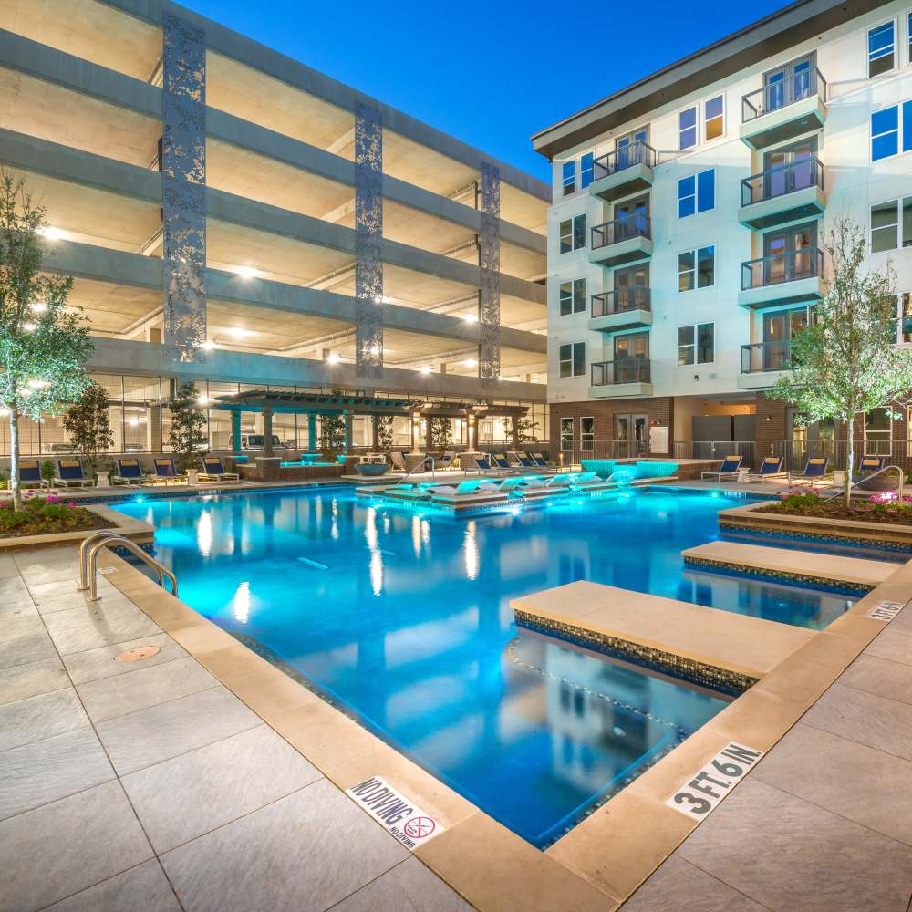 Summer kitchen with Al fresco dining beside the pool area at Hall Street Flats in Dallas, Texas