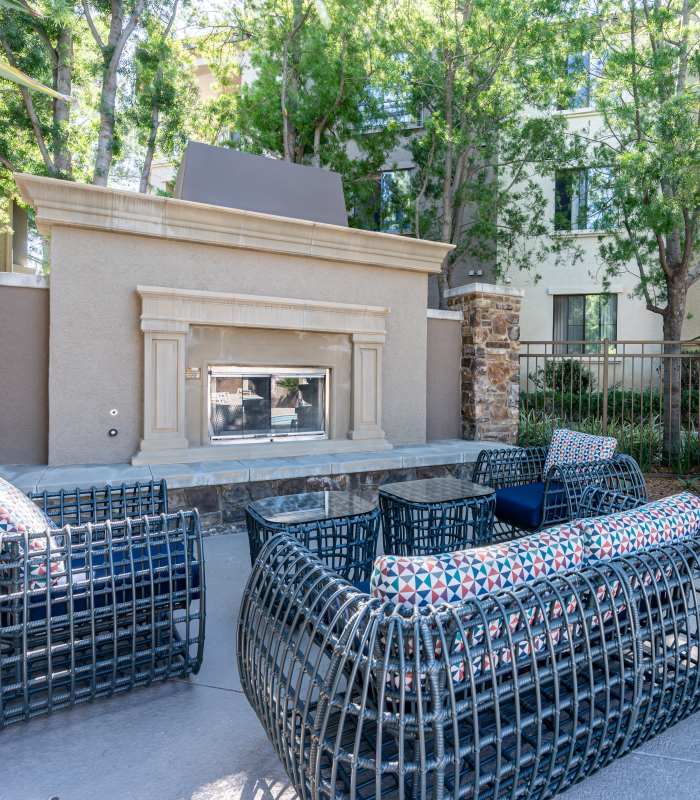 Outdoor seating area with fireplace at Links at Westridge in Valencia, California