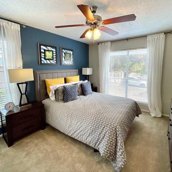 Bedroom with ceiling fan at The Abbey at Medical Center in San Antonio, Texas