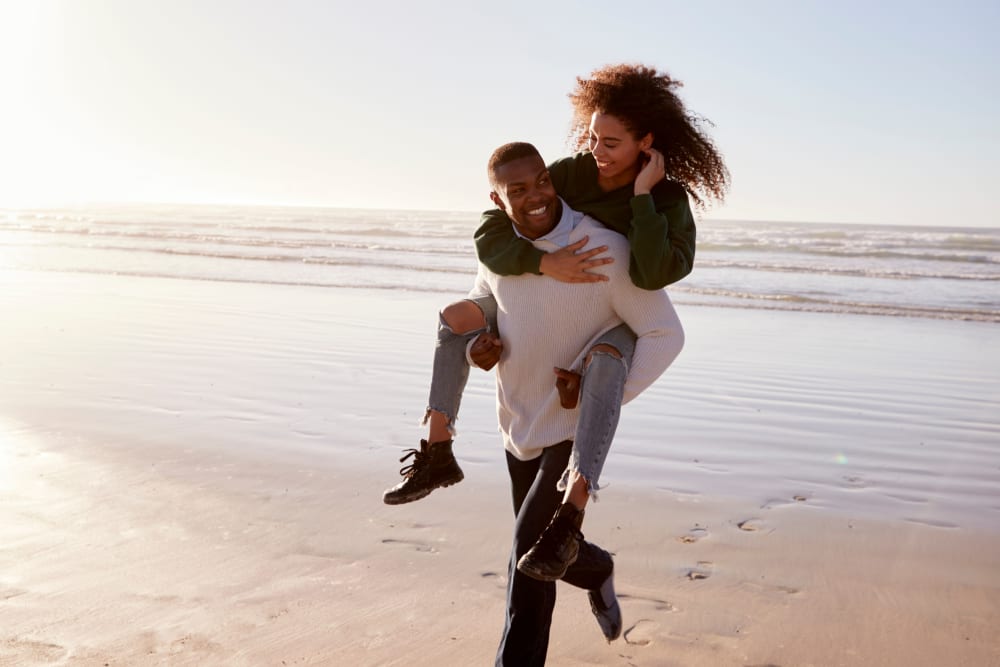 Couple walking on the beach near Glen Ellen Apartment Homes in Long Branch, New Jersey