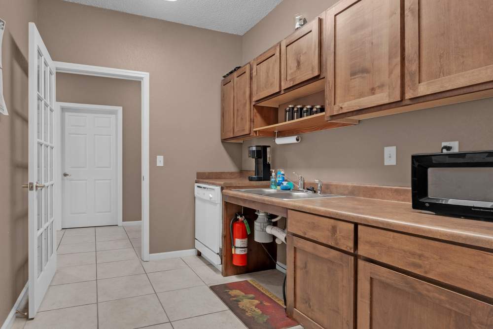 Bright and inviting modern kitchen with cozy wood cabinetry in Rolling Meadows Apartments in Glenpool, Oklahoma.