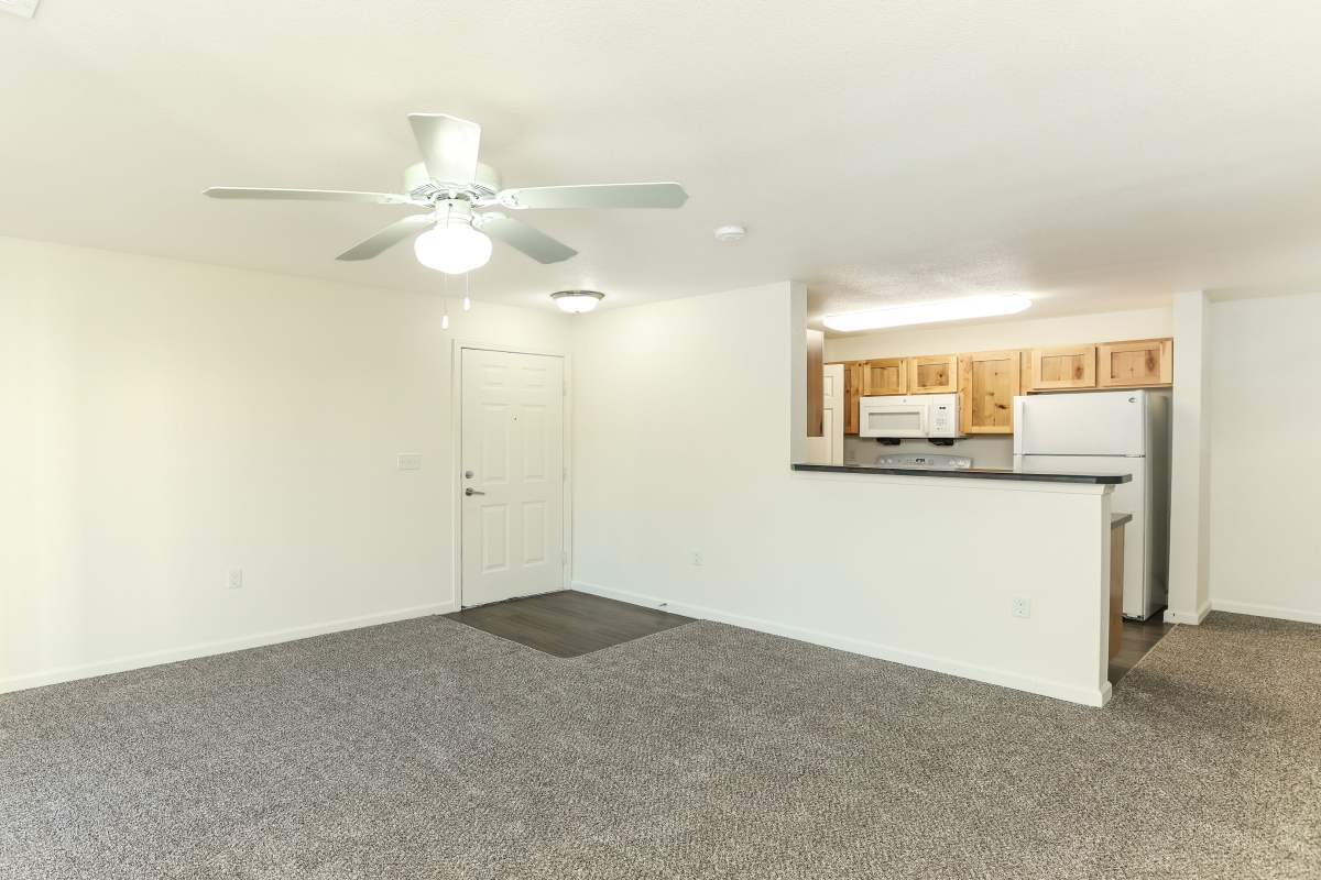 Open model living area and kitchen with white appliances at Broadstone II in Bel Aire, Kansas