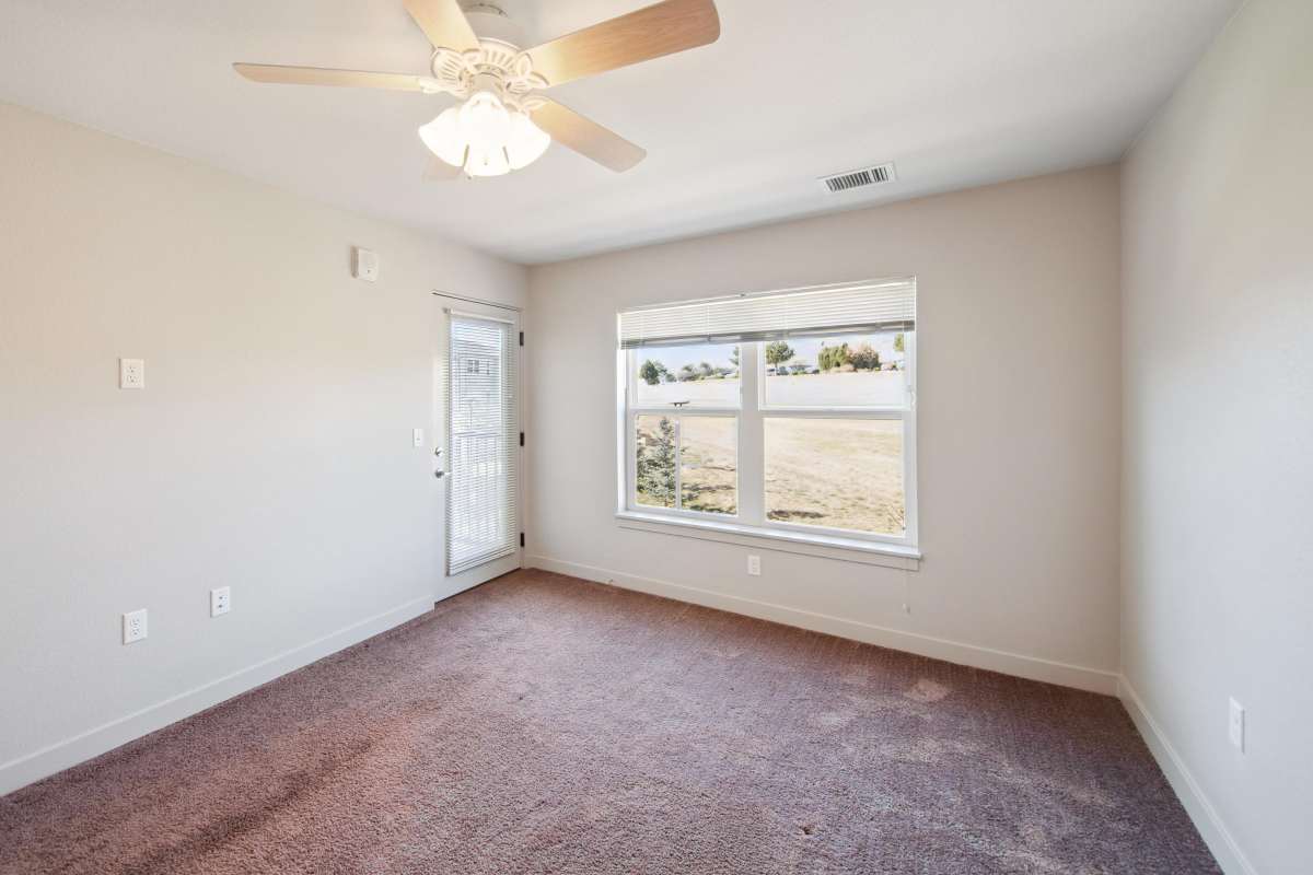 Well-lit and spacious apartment with ceiling fan at Villas At Mesa Ridge in Fountain, Colorado
