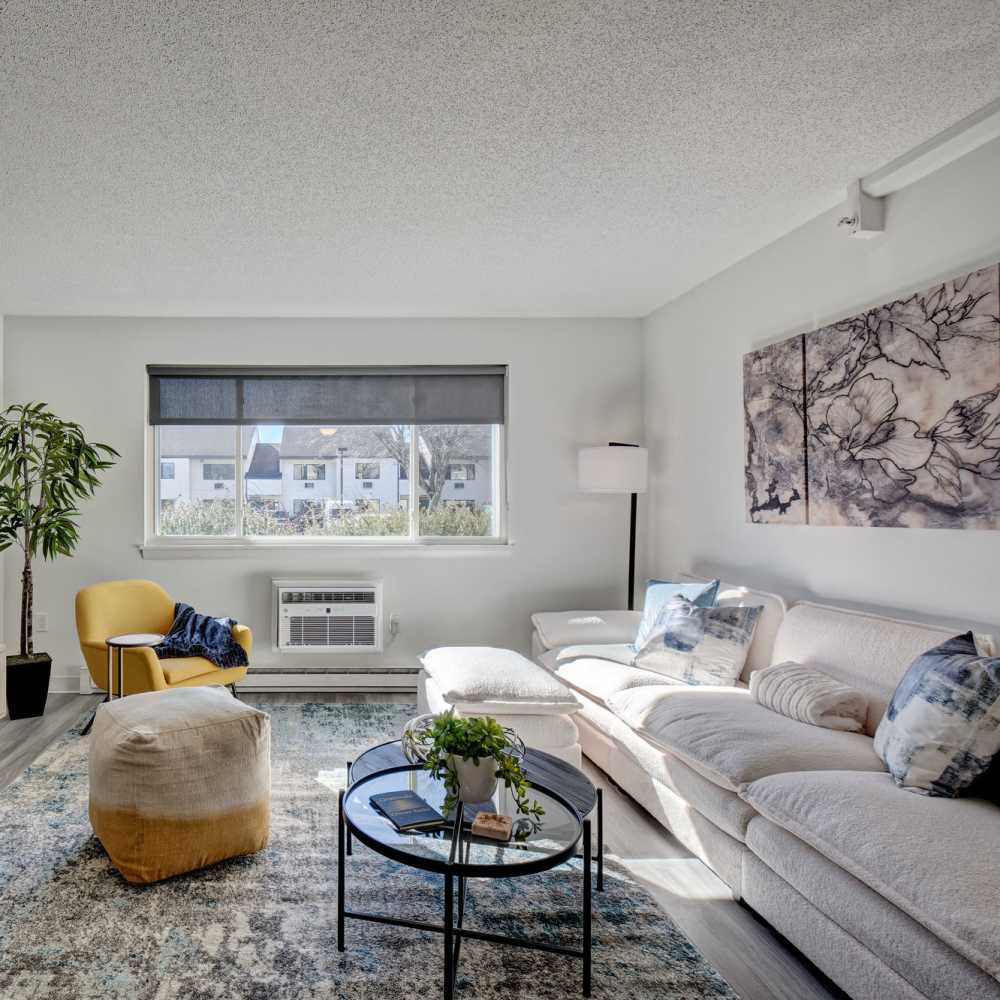 Well-furnished modern living area of an apartment at The Otis in Dallas, Texas