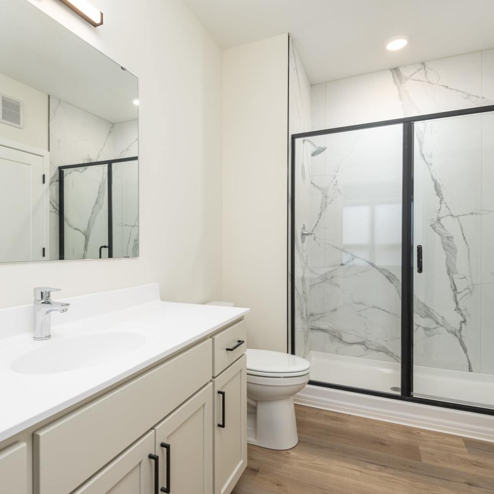 Bathroom with wood-style flooring at The Uptown Apartments in Waconia, Minnesota