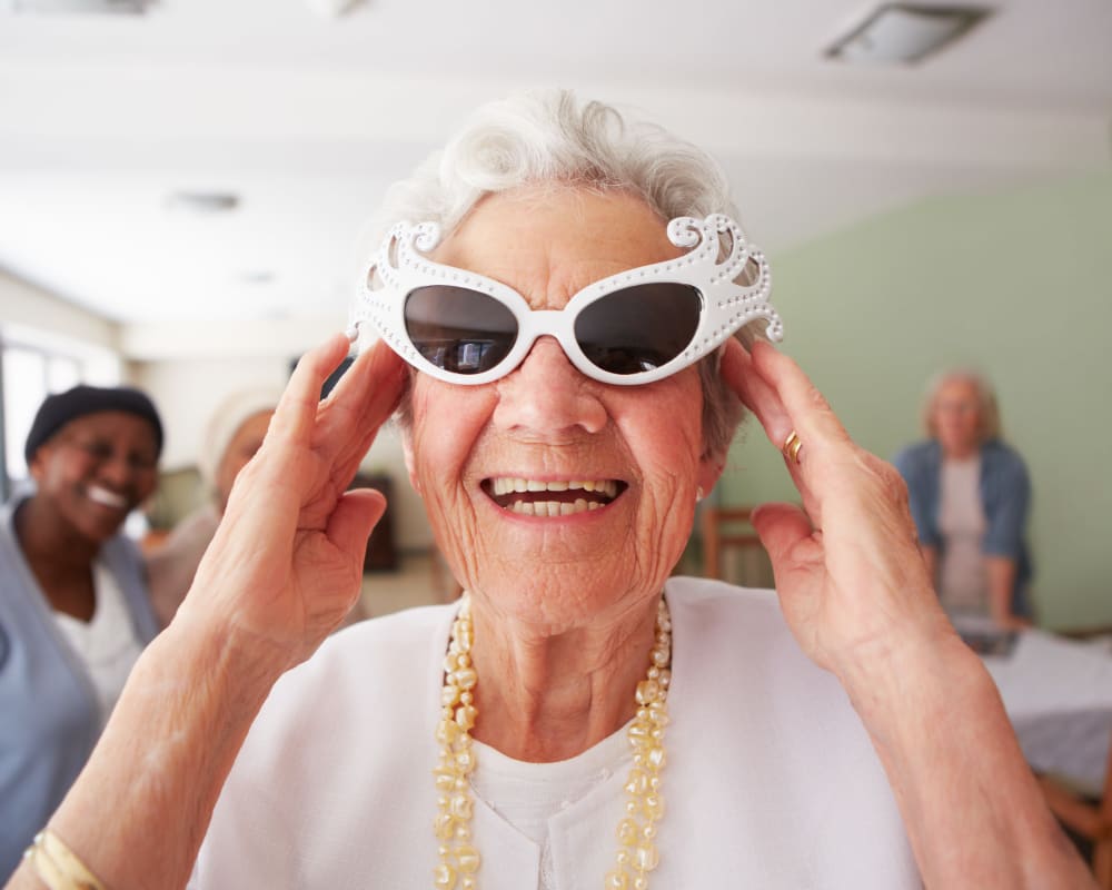 Resident wears fun sunglasses at Arlington Place of Grundy Center in Grundy Center, Iowa.