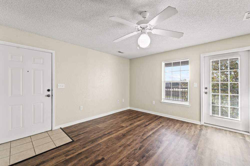 Well-lit apartment living area with ceiling fan at Callaway Village Phase II in Fulton, Missouri
