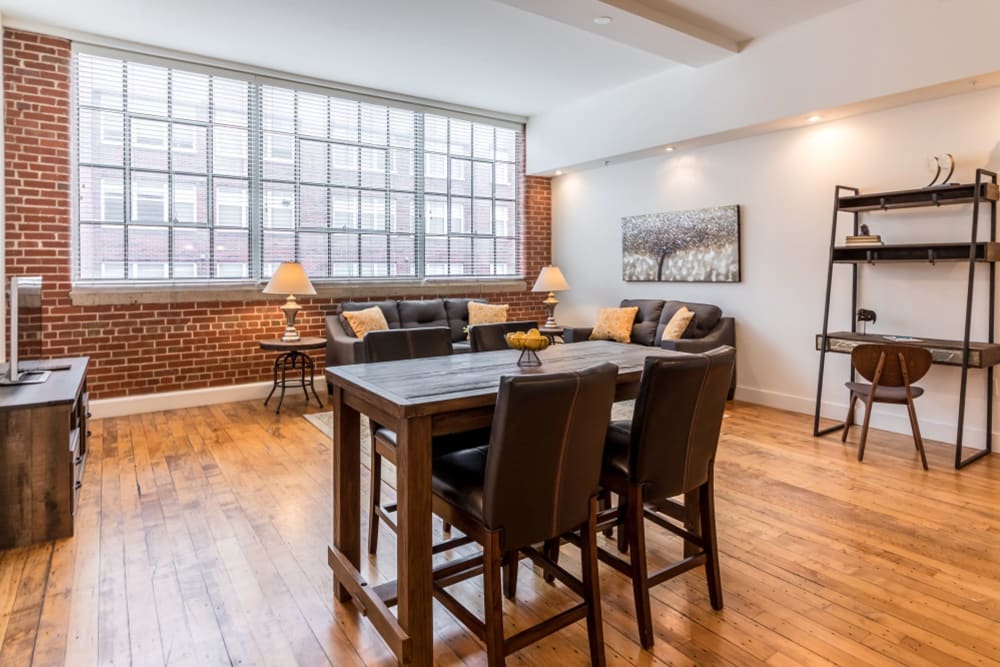Model dining area with large windows at The Gallery Lofts in Winston Salem, North Carolina